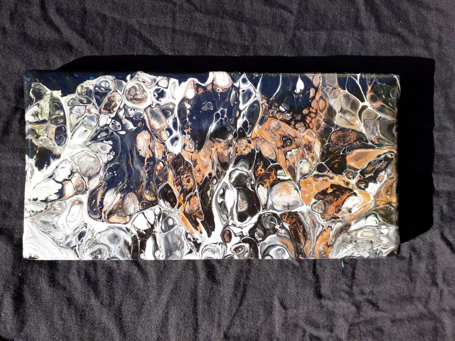 A vibrant acrylic pour painting with swirling colors and organic patterns